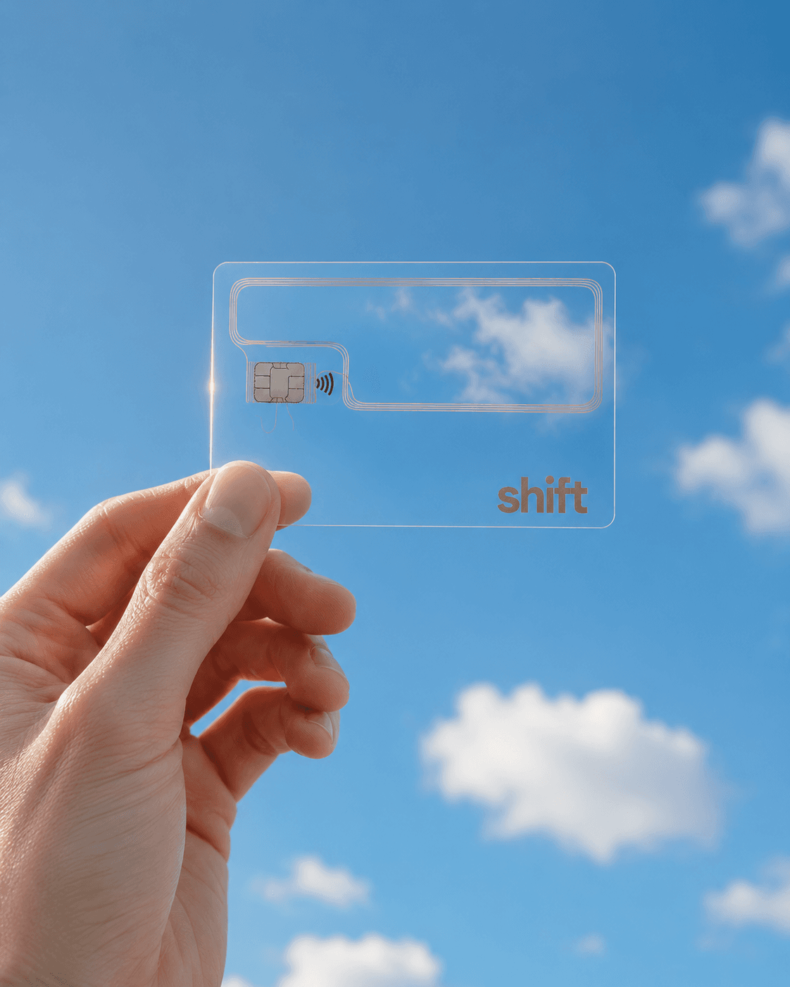 A hand holding the clear Void card against an open blue sky, the module and wordmark catching the light.