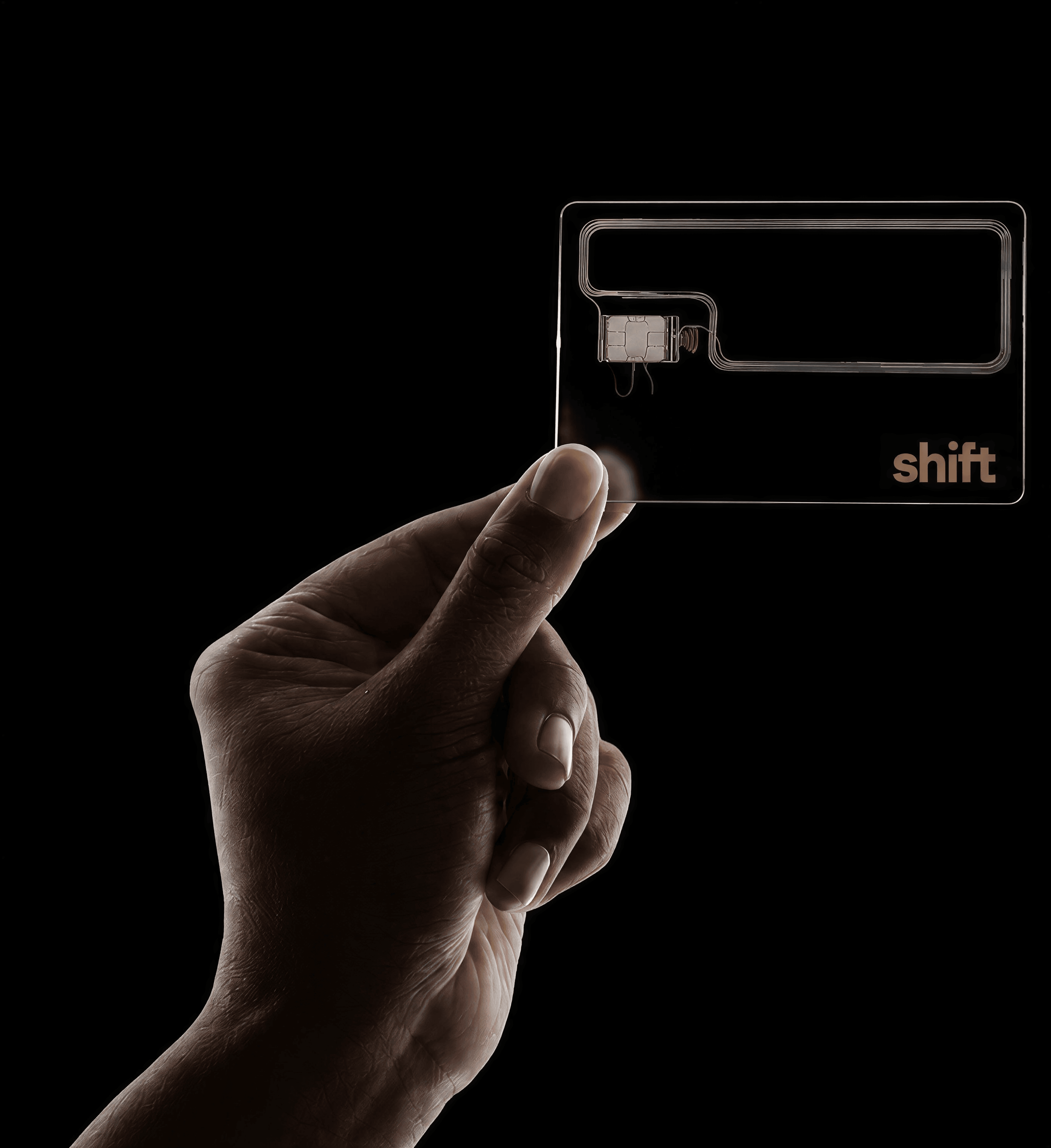 A hand holding the clear Shift card.