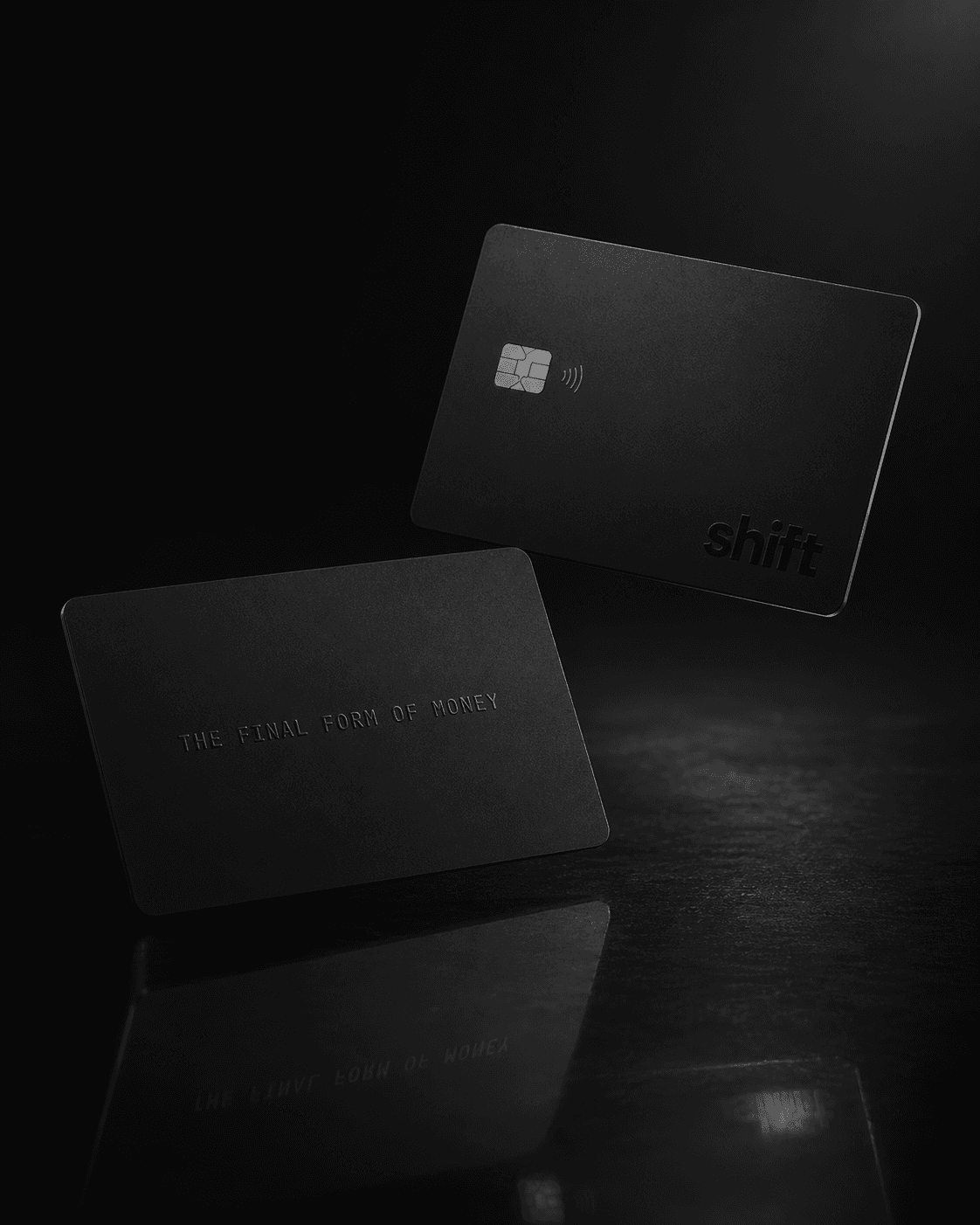 The Shift card, matte black, its silver secure element and contactless mark catching a studio key light.